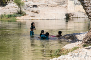 Children in the water, Wadi Bani Khalid, Oman