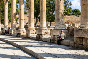 Woman seated in the Oval Plaza, South Theatre, Jerash Jordan