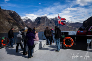 Flying the Norwegian flag on the Vision of the Fjords, Aurlandsfjord