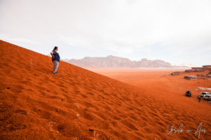 Woman on a red dune, Wadi Rum Jordan