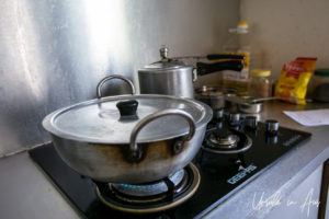 Pots on a gas stove in a kitchen.