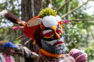 Portrait: Western Highland man in face paint smoking, Paiya Village, Papua New Guinea.