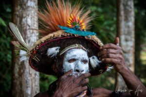 Portrait: Huli Wigman applying face paint, Paiya Village, Papua New Guinea.