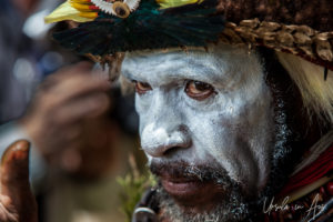 Portrait: Huli Wigman applying face paint, Paiya Village, Papua New Guinea.