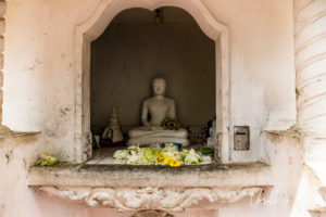 Buddha in a niche at the Dambulla Royal Cave Temple and Golden Temple, Sri Lanka