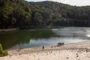 People at the edge of Lake Wabby, Fraser Island, Queensland Australia