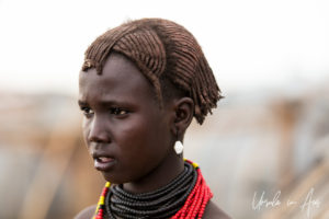 Young Daasanach Teen in red and black beads, Omo Valley Ethiopia