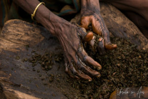 Woman's hands in wet patty mix, Daasanach Village, Omo Valley Ethiopia