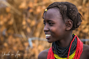 Young Daasanach Teen in red, yellow and black beads, Omo Valley Ethiopia