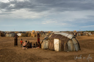 Daasanach people outside a corrugated iron hut, Omo Valley Ethiopia