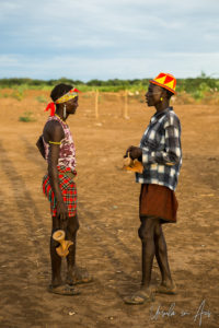 Two Daasanach Men standing chatting, Omo Valley Ethiopia