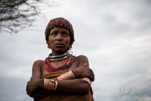 Portrait: A Hamar second wife against an overcast sky, Omo Valley Ethiopia