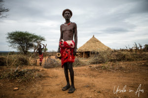 Hamar man with a wooden stool and a small-brimmed hat, Omo Valley Ethiopia