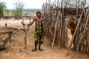 Hamar woman and girl at stick fence, Omo Valley Ethiopia