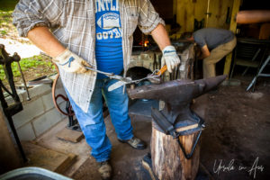 Working a metal knife on an anvil, Falls Mill, Belvidere TN USA