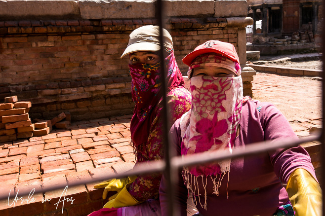 Nepali women in rubber gloves, caps and face scarves, Durbar Square, Patan Nepal