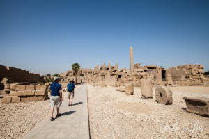 Visitors walking through the Akh Menou Temple, Karnak Egypt