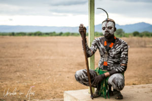 Kara man in clay paint on a building porch, Dus Ethiopia