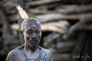 Portrait: Kara man face paint and ostrich feather, Dus Village, SNNPR Ethiopia