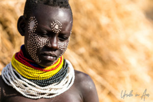 Portrait: young Kara woman in beads and face paint, Dus Village, SNNPR Ethiopia
