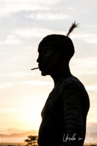 Portrait: Kara warrior in profile silhouette, Omo Valley, Ethiopia