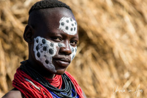Portrait: Kara woman in face paint, Dus Village, Omo Valley Ethiopia