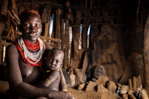 Kara mother and infant in a hut, Dus Village, Omo Valley Ethiopia