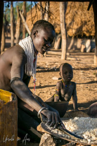 Kara woman preparing sorghum, Omo Valley Ethiopia