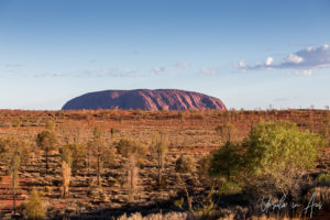 Uluru across a semi-arid plain, Yulara, NT Australia