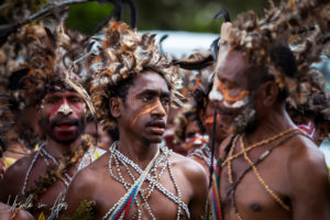 Papuan men In brown feathered headdresses, Mount Hagen PNG.