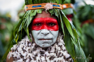 Portrait: Black Mama Wurwur woman in sing-sing paint and headdress, Mt Hagen Papua New Guinea