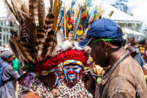 Western Highland man applying face paint to a woman, Mt Hagen, Papua New Guinea