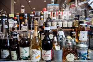 Shop window: bottles of calvados and cider, Honfleur, France