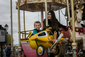 Woman and child on the Carrousel in Honfleur, France
