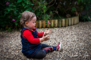 Toddler on a pathway, Wye Valley Butterfly Zoo, Herefordshire, UK.