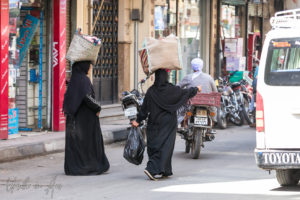 Women in Black Abayas with shopping on their heads, Luxor Egypt