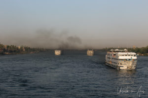 Riverboats in clouds of diesel smoke on the Nile, Egypt.