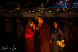 A woman namastes a monk, Boudhanath, Kathmandu Nepal
