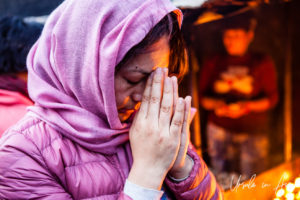 Portrait: Nepali woman praying, Boudhanath, Kathmandu