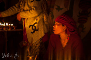 Nepali woman in candlelight, Boudhanath, Kathmandu