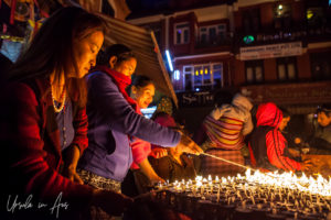 Nepali women lighting lamps, Boudhanath, Kathmandu