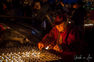 Buddhist monk lighting candles, Boudhanath, Kathmandu