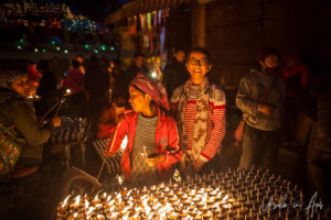 Young Nepali man and women at a candle table, Boudhanath, Kathmandu