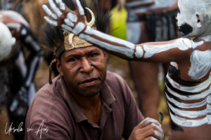 Close-up: man Painting a Skeleton boy, Mt Hagen Papua New Guinea.