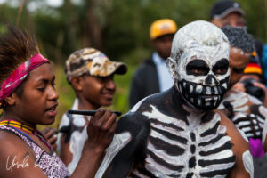Simbu woman painting a skeleton man, Mt Hagen Papua New Guinea.