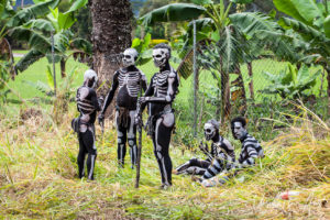 Group of skeleton men in the grass, Mt Hagen Papua New Guinea