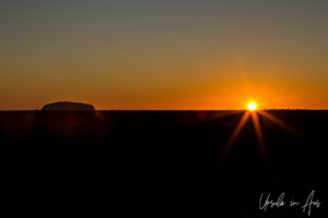 Sun on the horizon at Uluru, NT Australia