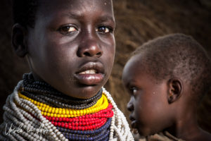 Portrait: Girl with a toddler, Omo River Ethiopia