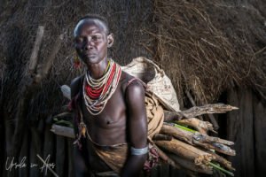 Older Kara woman carrying wood, Dus Village Ethiopia