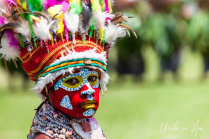 Portrait: young Melpa woman in face paint and feathered headdress, Mt Hagan Cultural Show, PNG